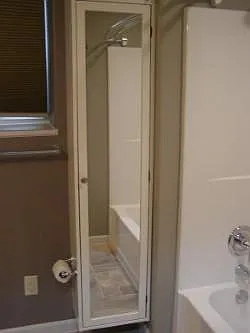Bathroom built in mirrored storage.