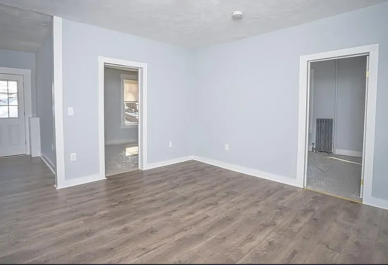 Kitchen hallway, with view of entrances of 2nd & 3rd bedrooms and part of livingroom.