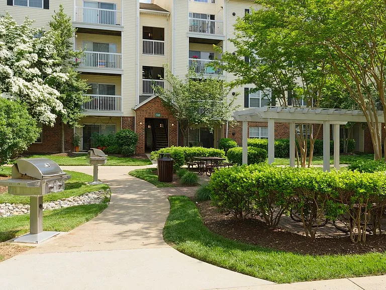 Landscaped courtyard with barbecue grills and seating