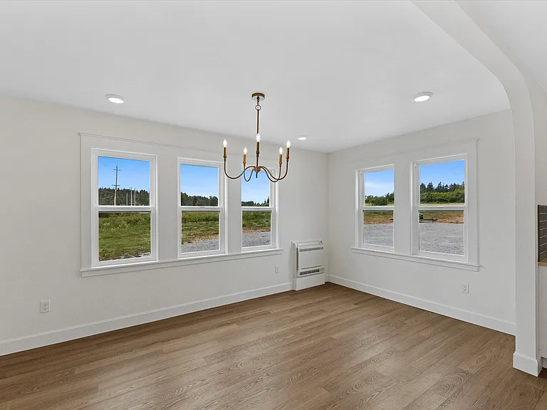 Easily fit a long rectangular dining room table in this space.