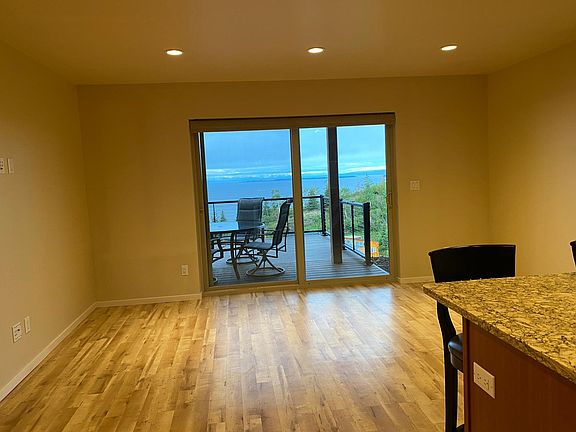 Living room and private deck with views of Fire Island, Mt. McKinley (Denali) and the Alaska Range.
