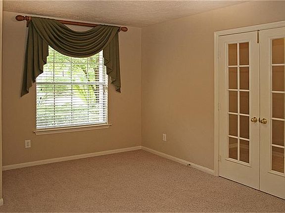 Double French doors and a large window grace the study.