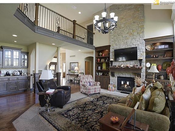 Ceiling to floor stone fireplace, built-ins, & plantation shutters brings custom quality finishings to this home.