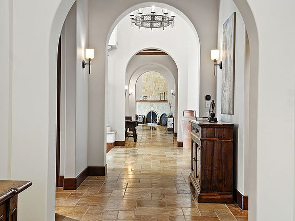 Step into a world of timeless sophistication, where graceful arches and sweeping hallways create an atmosphere of grandeur and serenity