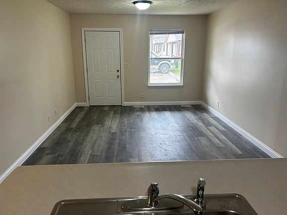 Standing in kitchen facing front entry and living room