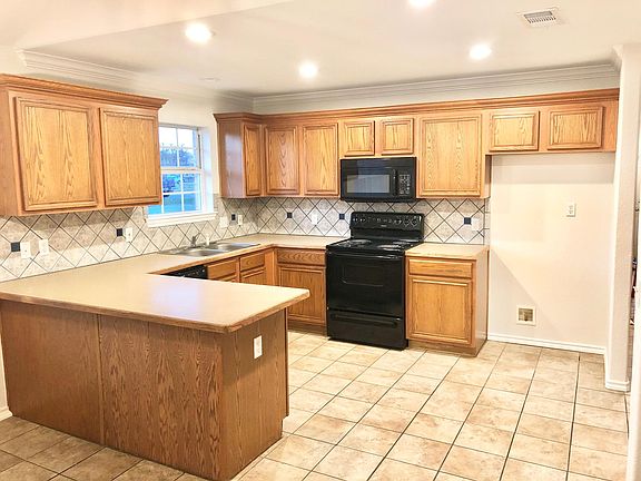 Kitchen with pantry (not pictured) with lots of cabinetry. Appliances included are oven, microwave, and dishwasher