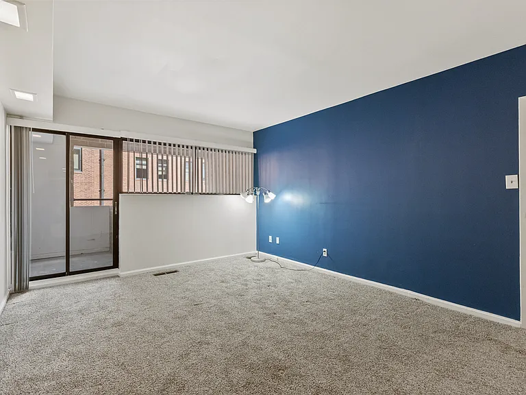 Primary bedroom with ensuite full bathroom and balcony to outside