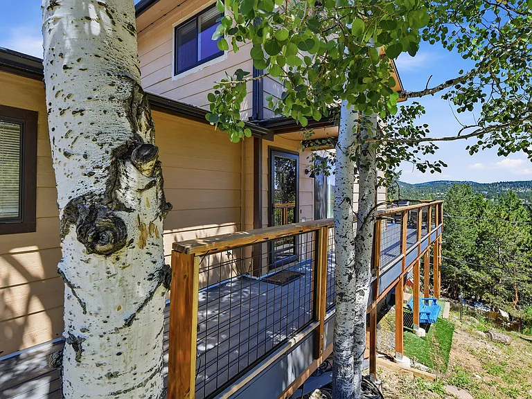 Your favorite room in the house. This brand-new wraparound deck offers the perfect place to relax, entertain, or enjoy peaceful mountain mornings surrounded by towering pines.