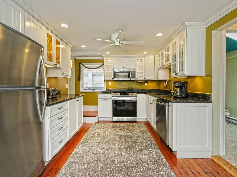 Updated kitchen with stainless-steel appliances and granite countertops.