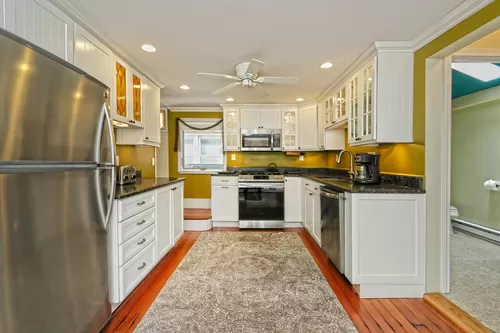 Updated kitchen with stainless-steel appliances and granite countertops. - 13 Billow Rd