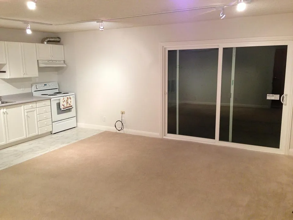 Sliding glass doors open onto wood deck & back yard