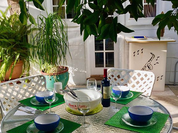 The outdoor breakfast/dinner area is conveniently located next to the side entrance leading to the kitchen.