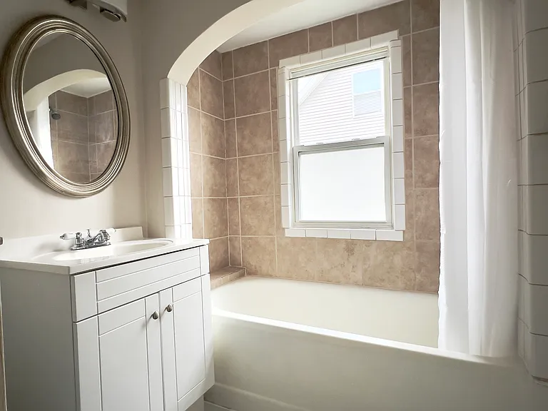 Bathroom with premium flooring, tub/shower and plenty of natural light