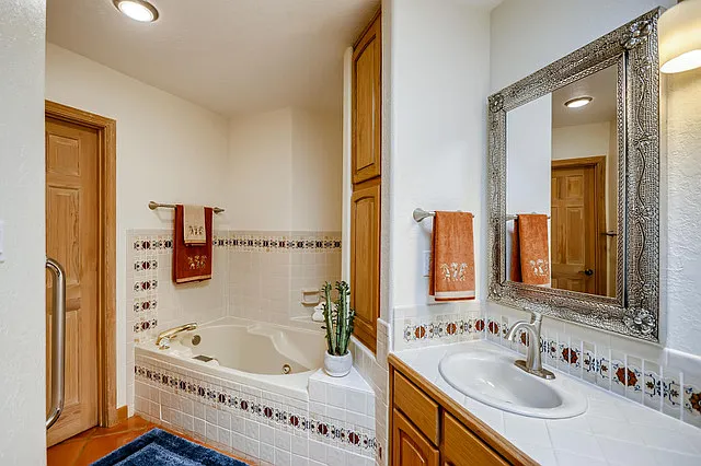master bath Jacuzzi tub ... water closet behind closed door and stand alone shower on opposite wall