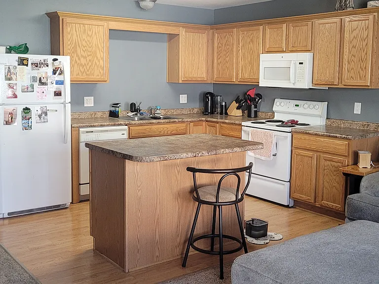 Living room to kitchen - -open floor plan, kitchen island, lots of cabinet and counter space.