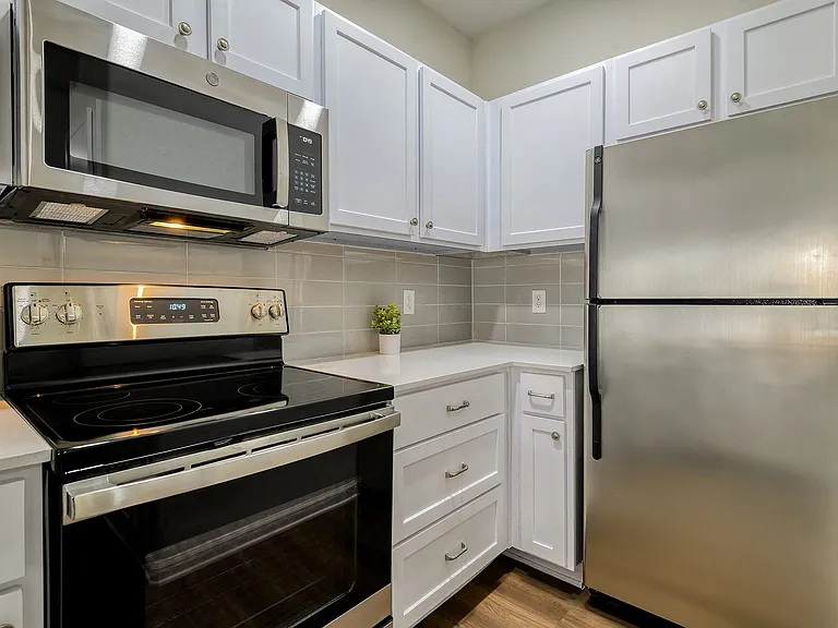 Gourmet kitchens with stainless steel appliances.