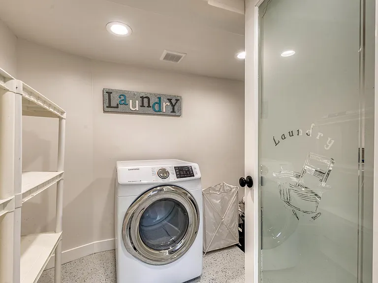 Laundry room in the basement with lots of storage