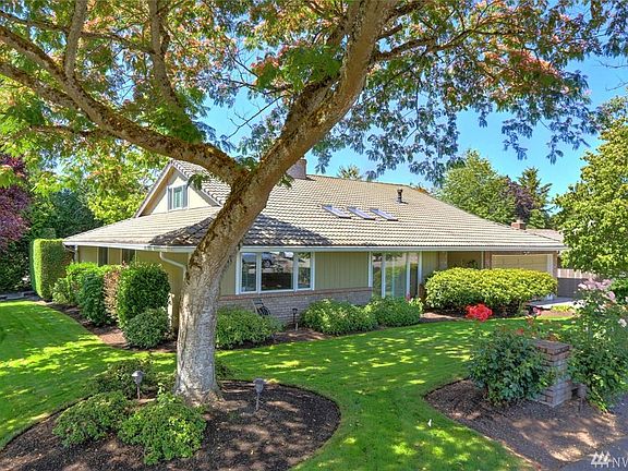 This home sits on a sweeping corner lot boasting graceful, established landscaping. This gorgeous tree provides summertime shade