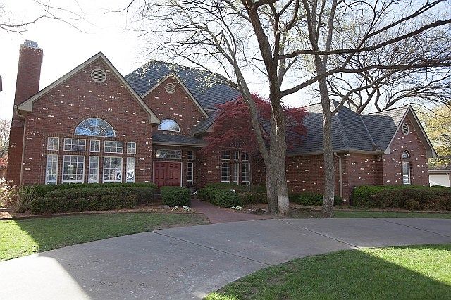Stately brick on corner lot with circular drive