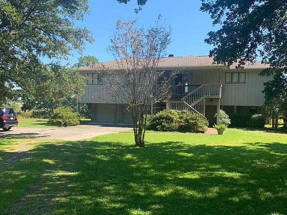 Front of house coming down driveway.