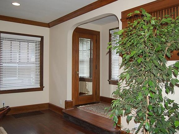 Arched stair landing. Note spindled opening and beveled glass closet door mirror.