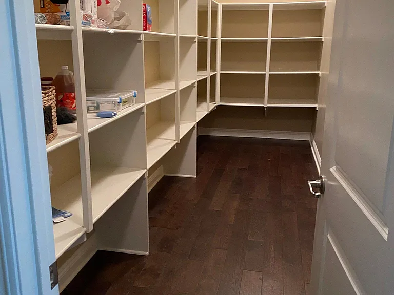 Enormous kitchen pantry with built in shelving.