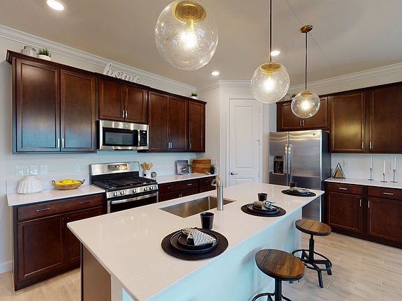 A stylish kitchen showcases low-maintenance efficiency with a new stainless-steel appliance package