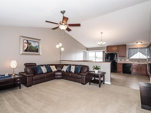 The open floor plan with vaulted ceilings welcomes you from the entry way!