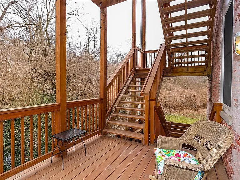 Second Floor with partially covered walk out deck with wooded and river views