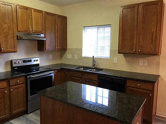 Beautiful kitchen featuring granite counters and tile backsp