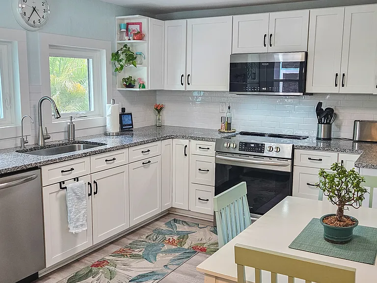 Kitchen with diinette, stove, dishwasher.