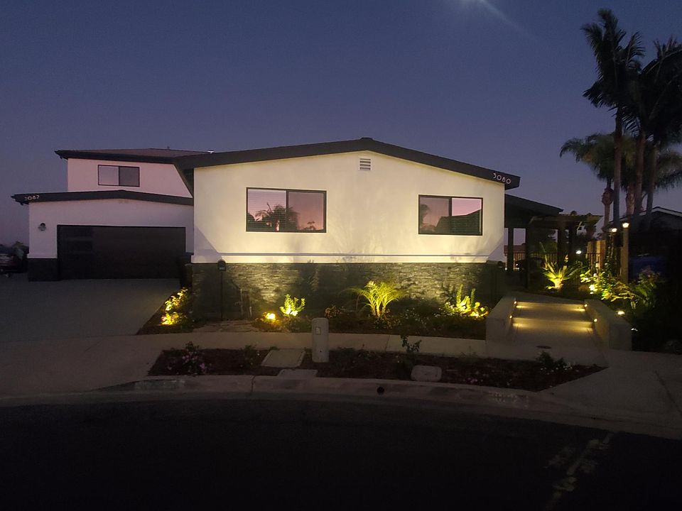 New black windows, and white stucco.