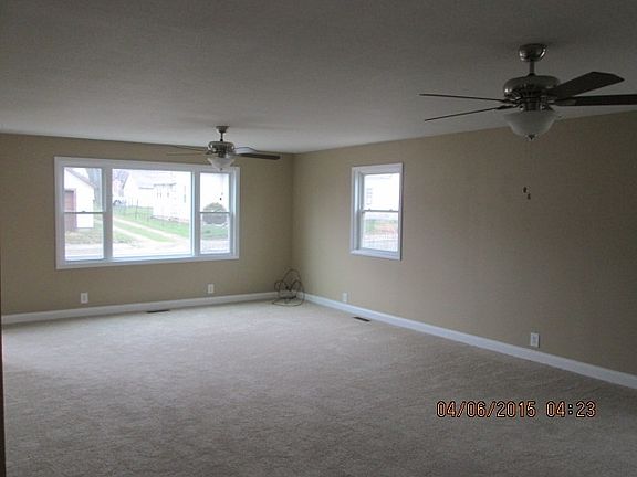 living room has all new carpet, ceiling fan, New thermo pane windows.