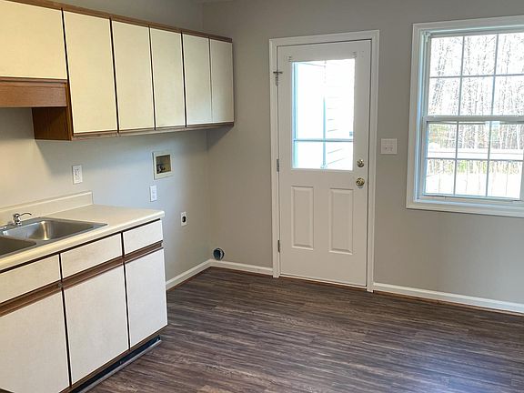 Kitchen with laundry hookups and door leading to rear deck