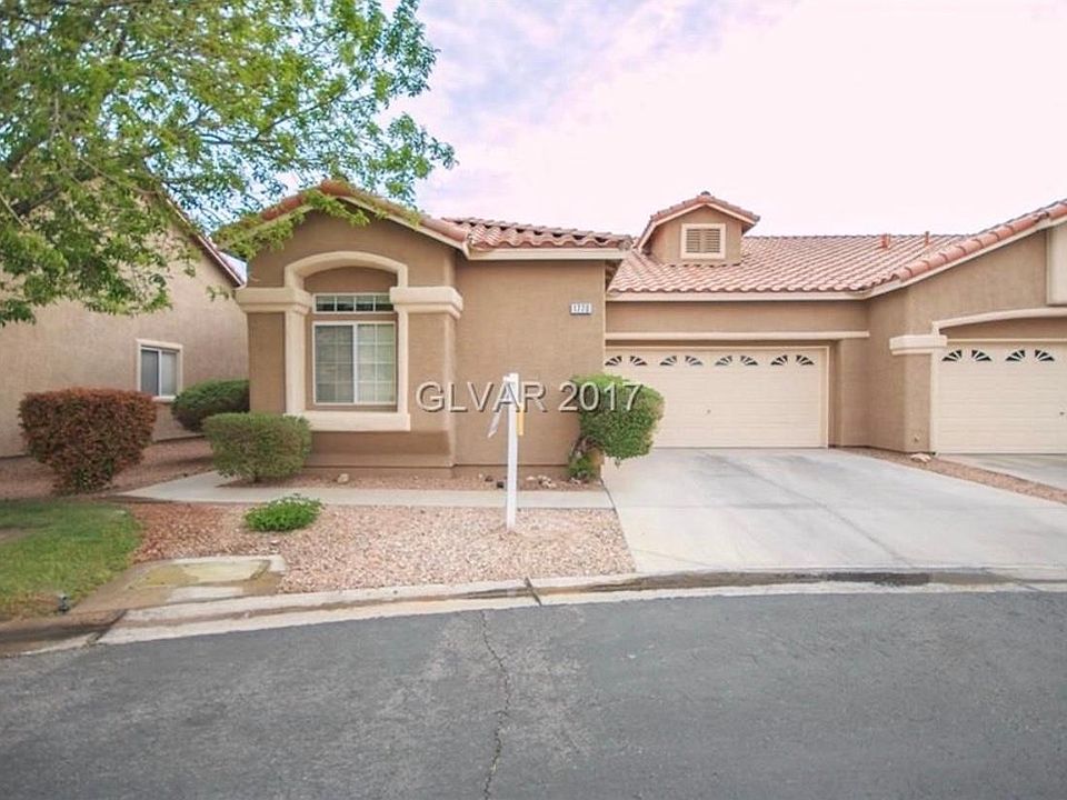 Front of house w/ 2 car garage.