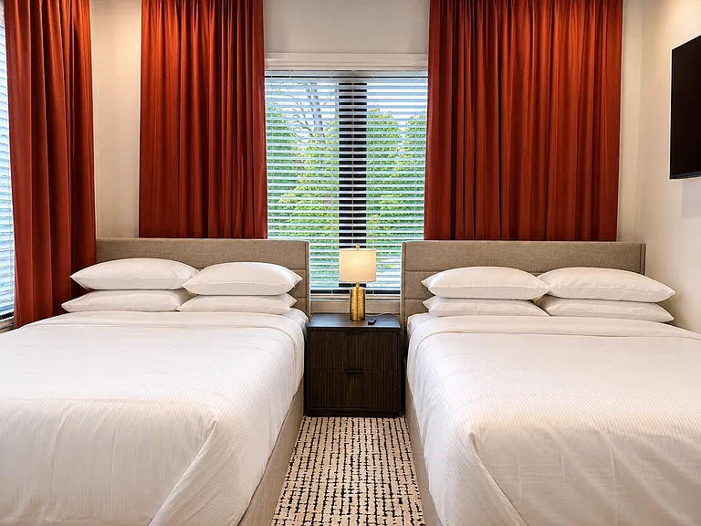 Welcome to the Kirkwood Suite. This double queen retreat with plush bedding, Smart TV, blackout curtains, and lounge-worthy comfort is designed for restful sleep, peaceful mornings, and cozy late-night streaming after a day exploring Atlanta.