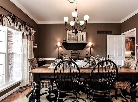 Dining room shows attention to detail with crown molding, chair rail and wood floors.