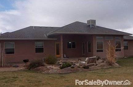 Back of house faces creek/green space. : large irrigated yard with flagstone patio