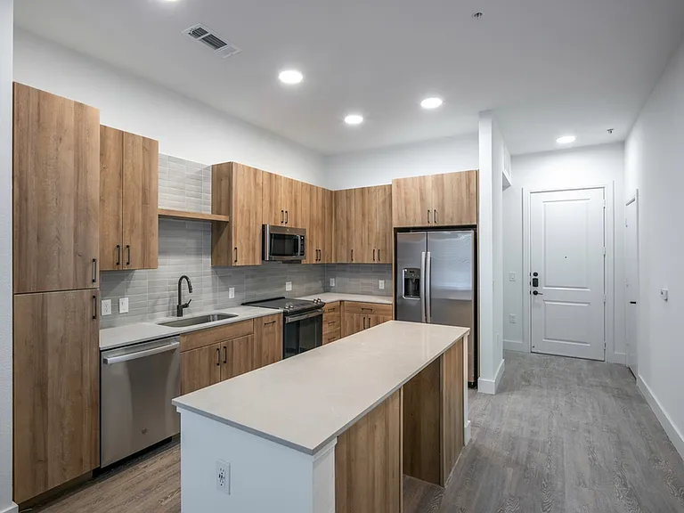 Experience culinary excellence in Modera Trinity gourmet kitchens, adorned with sleek quartz countertops and stylish tile backsplashes.