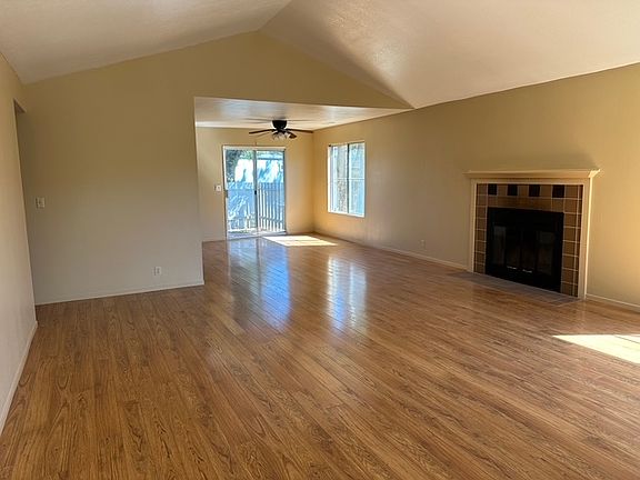 Living room with fireplace and dining room.