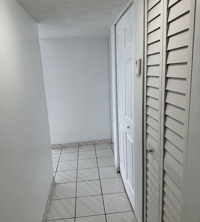 Hallway entry with two closet spaces