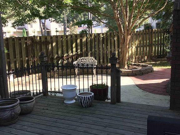 Back yard
						:
						Wooded deck with antique hand-forged iron fencing, concrete and paver patio