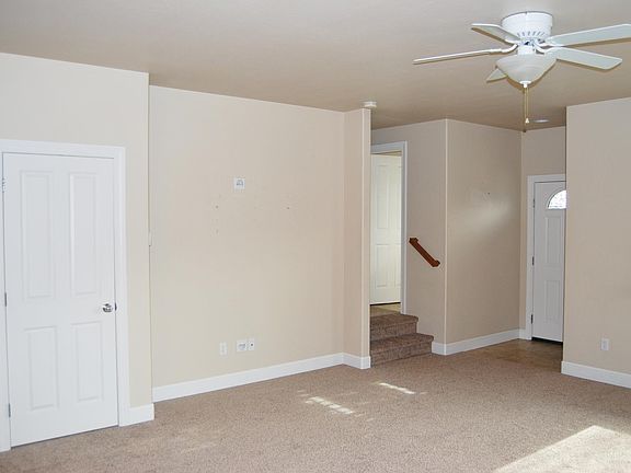 Living room, storage under stairs, 2 steps to 1/2 bath