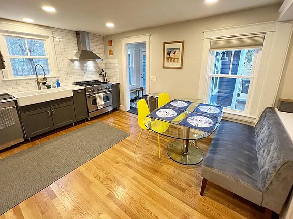 Newly renovated kitchen with comfortable dining that opens to cozy living room.