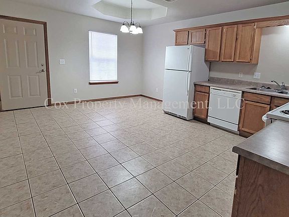 Front door, dining area, and kitchen