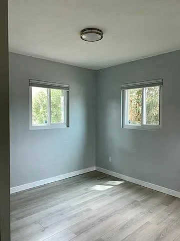Bedroom #3 w 2'x5' mirrored closet, view of the backyard