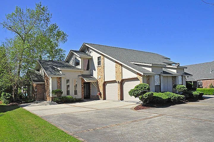 View of the garage and side door & spacious U-shaped driveway