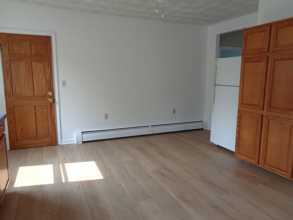 Plenty of room for a table and chairs. No additional wall mounted shelving allowed and no additional wall mounted hook/rods allowed.