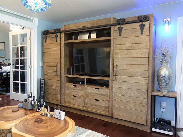 Entertainment center offers a wide collection of CDs, blue rays, and a blue-tooth stereo.