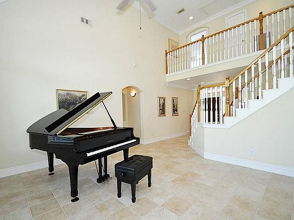 Two story formal living room with ceiling fan for extra air circulation